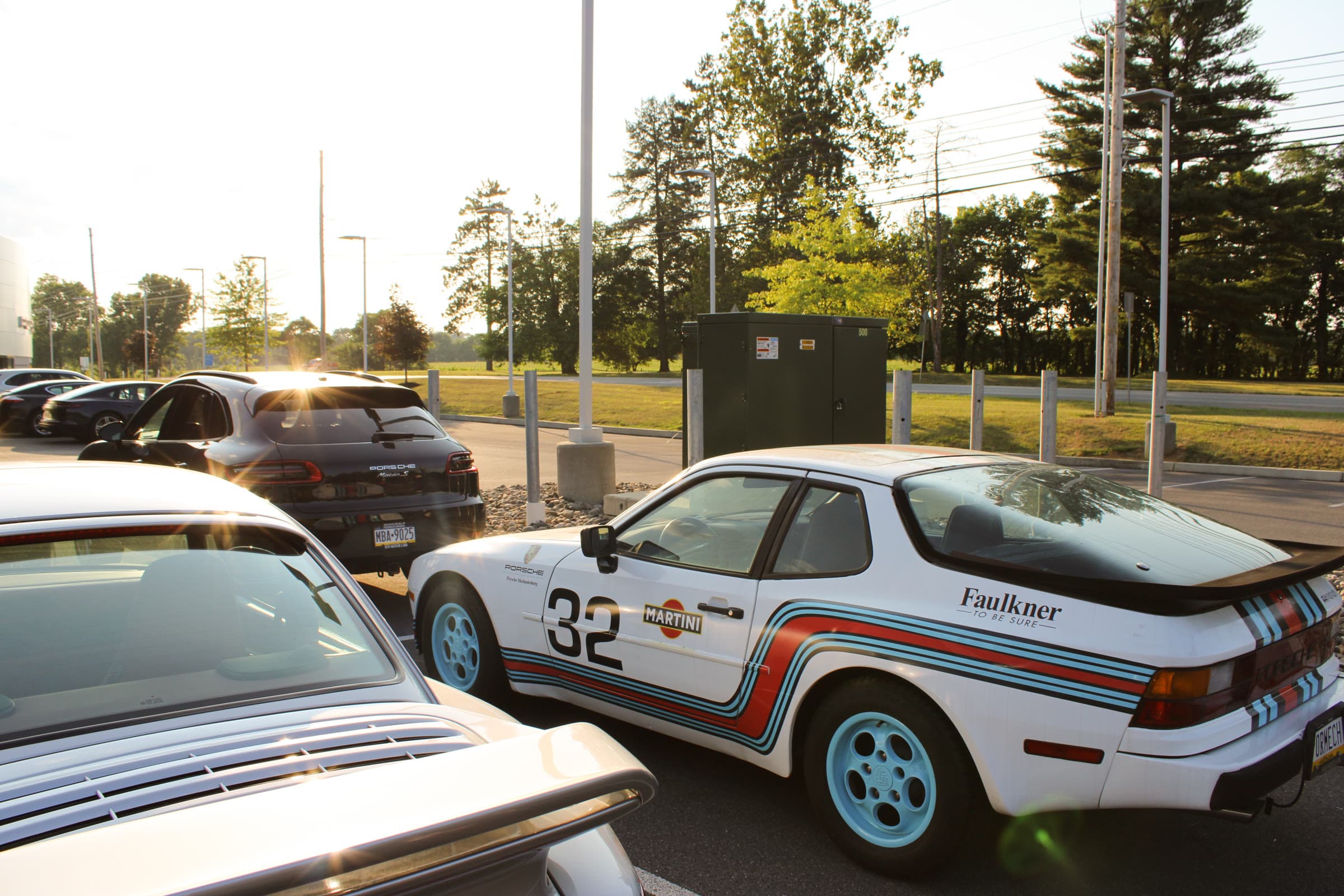 Conrad Captures photograph: white vintage Porsche in Martini Racing livery, number 32, golden hour in a parking lot.
